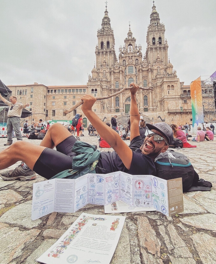 Peregrino con la Credencial y la Compostela ante la Catedral de Santiago